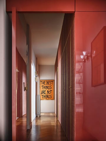 glossy dark red hallway with graffiti artwork at end of hall