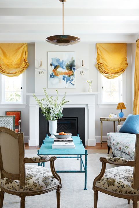 colorful living room in california with antiques and yellow silk curtains