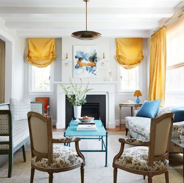 colorful living room in california with antiques and yellow silk curtains