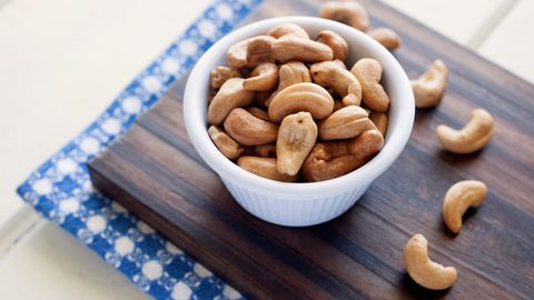 Close-Up Of Cashews In Bowl On Cutting Board
