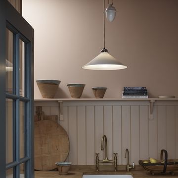 a kitchen with a sink and a shelf with bowls on it