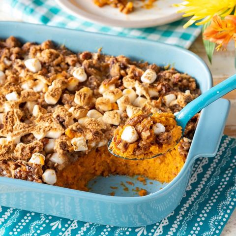 sweet potato casserole with marshmallows blue dish and spoon