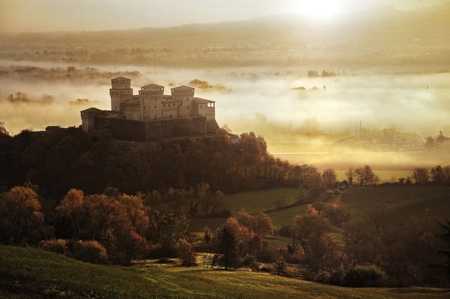 castello di torrechiara on hill at sunrise, parma, italy