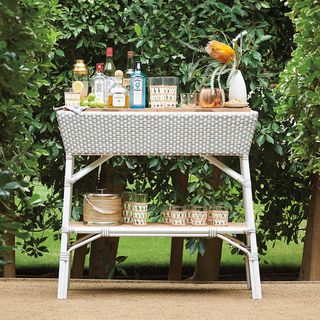 white bar cart in hedges