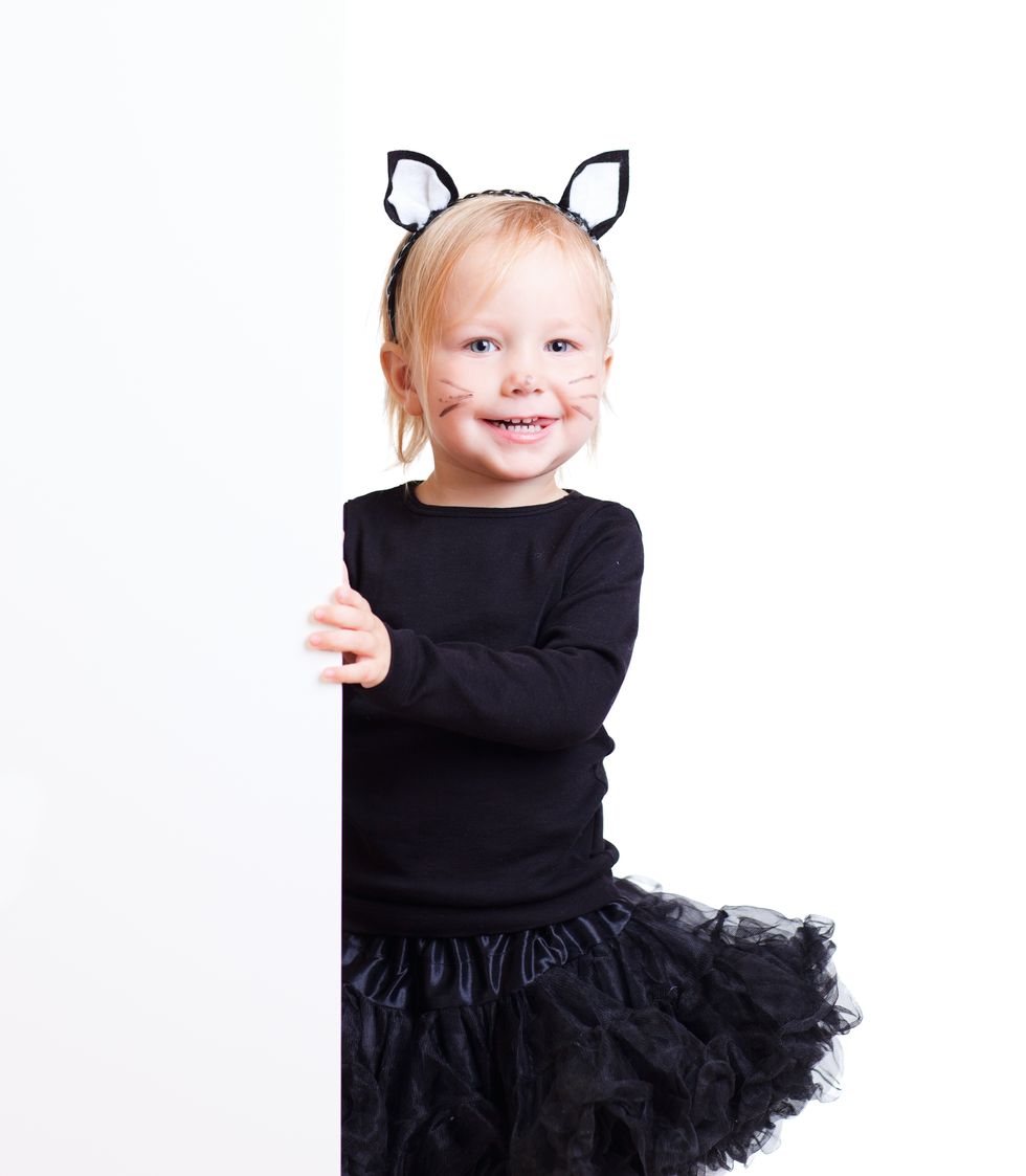 toddler dressed in cat ears headband, black long sleeve top, and black tutu for last minute diy halloween costume