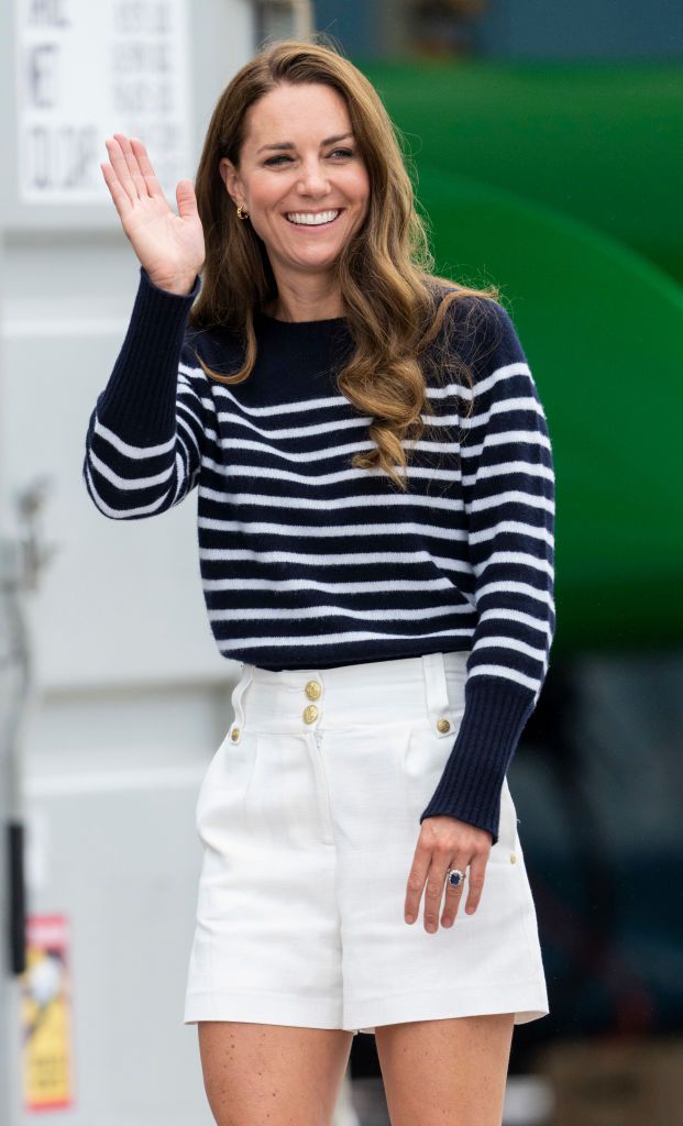 Duchess Catherine in black top, black cardigan, white skirt, and