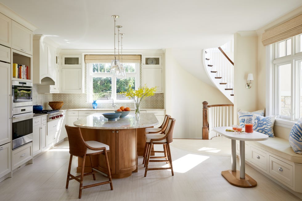 a kitchen with a dining table and chairs