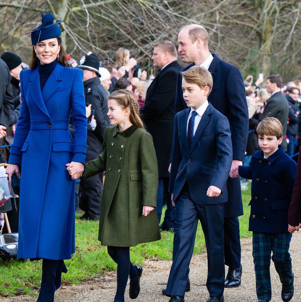 kate middleton, princess charlotte, prince william, prince george and prince louis walk hand in hand outside past a crowd of people in the background