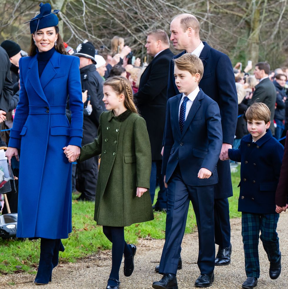 kate middleton, princess charlotte, prince william, prince george and prince louis walk hand in hand outside past a crowd of people in the background