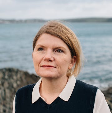 a person standing by a rock