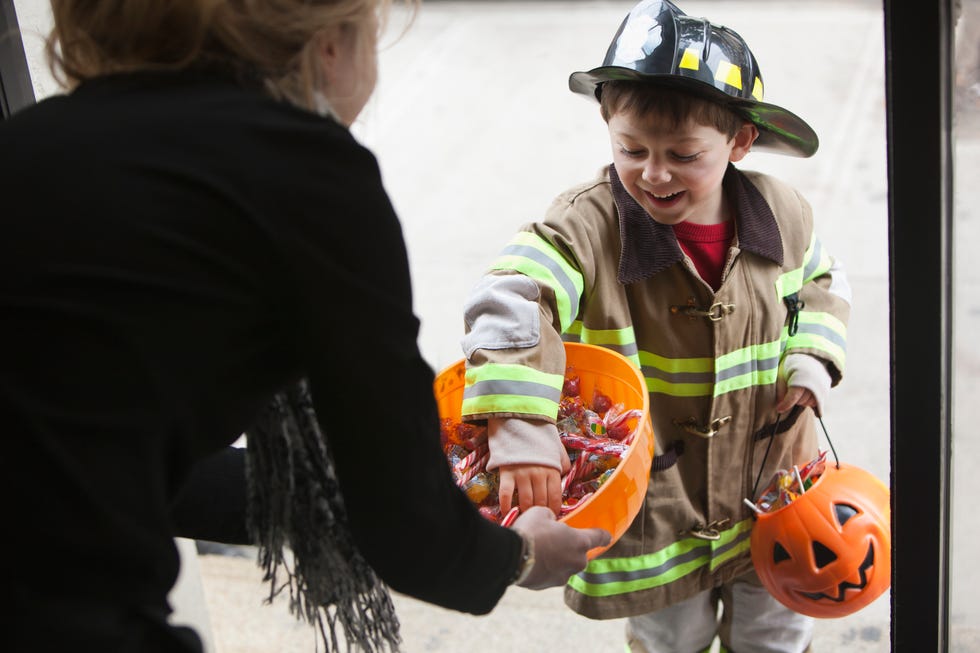 Caucasian boy trick or treating on Halloween