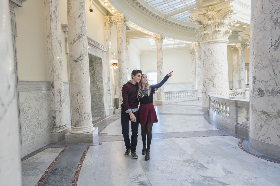 Caucasian couple touring capitol building