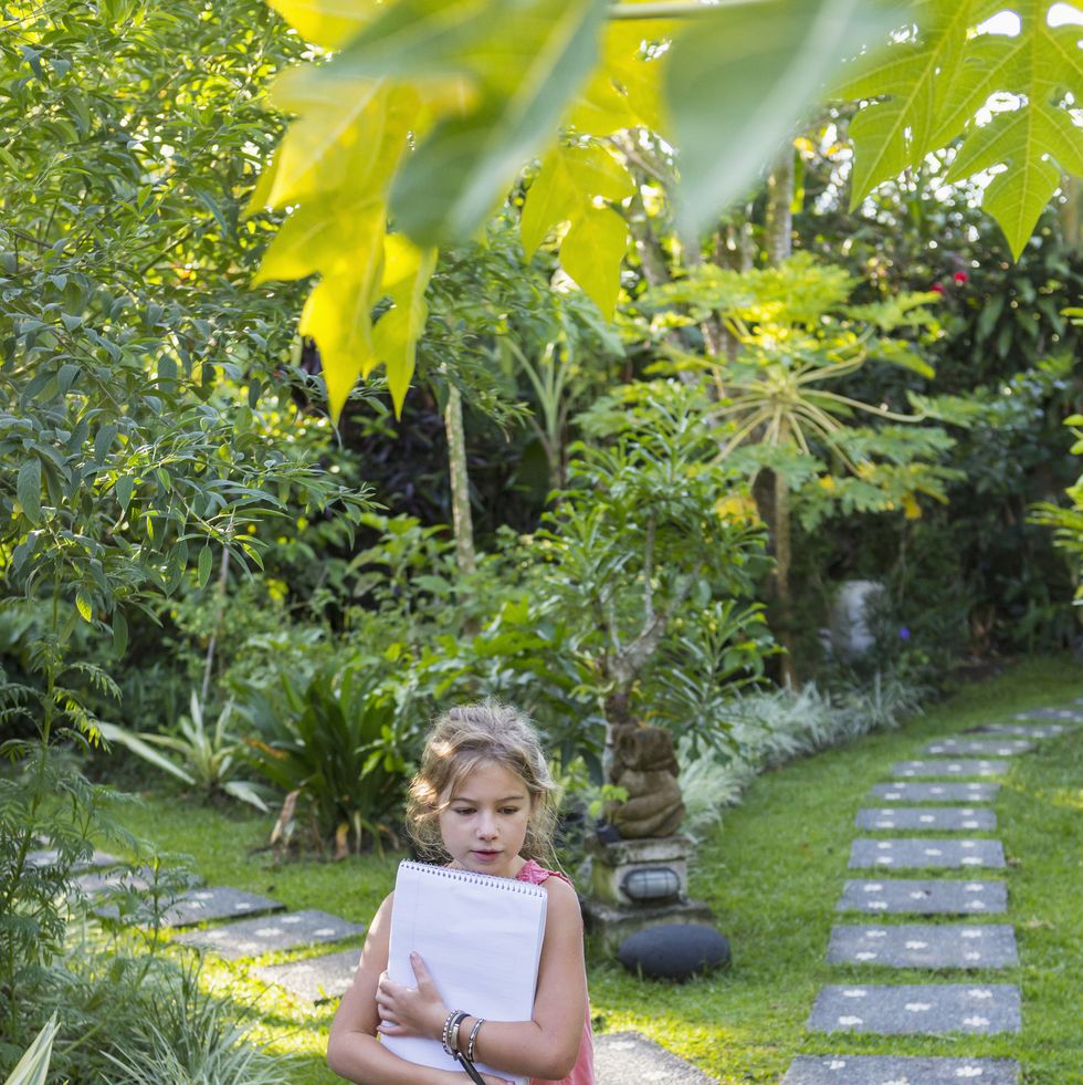 caucasian girl with notebook in backyard fun activities for kids