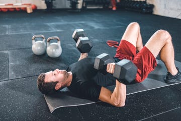 caucasian man doing exercises for the chest using dumbbels