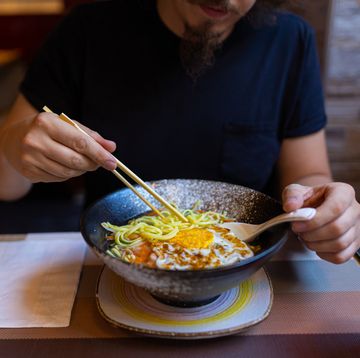 caucasian man eating japanese noodle soup