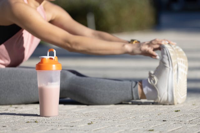 https://hips.hearstapps.com/hmg-prod/images/caucasian-millennial-woman-stretches-on-the-cement-royalty-free-image-1698168242.jpg?crop=1.00xw:0.753xh;0,0.161xh&resize=640:*