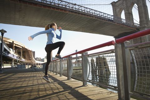 Caucasian runner stretching on waterfront, New York, New York, United States