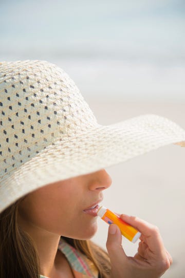 applying sunscreen lip balm at beach