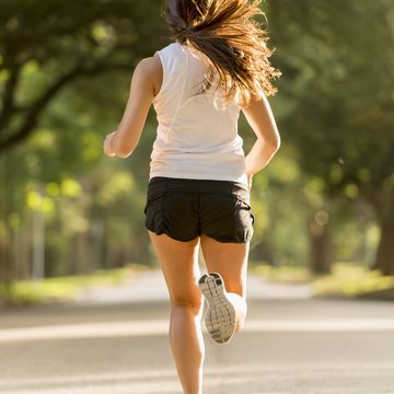 caucasian woman jogging on neighborhood street