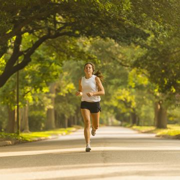 caucasian woman jogging on neighborhood street