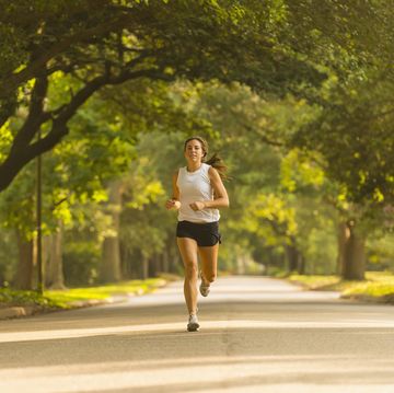 caucasian woman jogging on neighborhood street