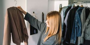 caucasian woman organizing closet at home,spain