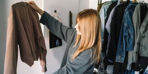 caucasian woman organizing closet at home,spain
