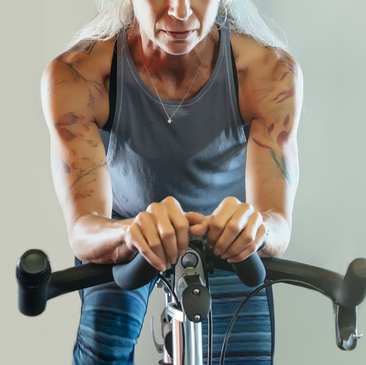 Caucasian woman riding stationary bicycle