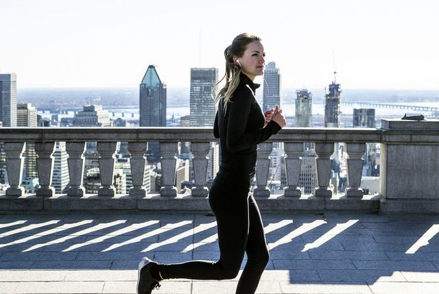caucasian woman running in city