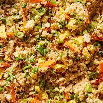 cauliflower fried rice with carrots, green onion, and eggs topped with sesame seeds