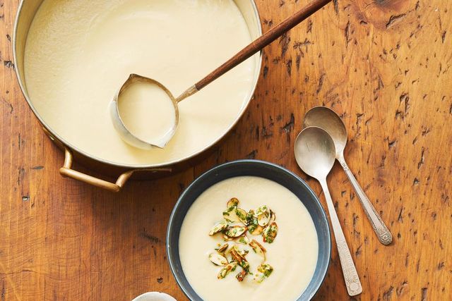 a pot and a bowl of cauliflower soup