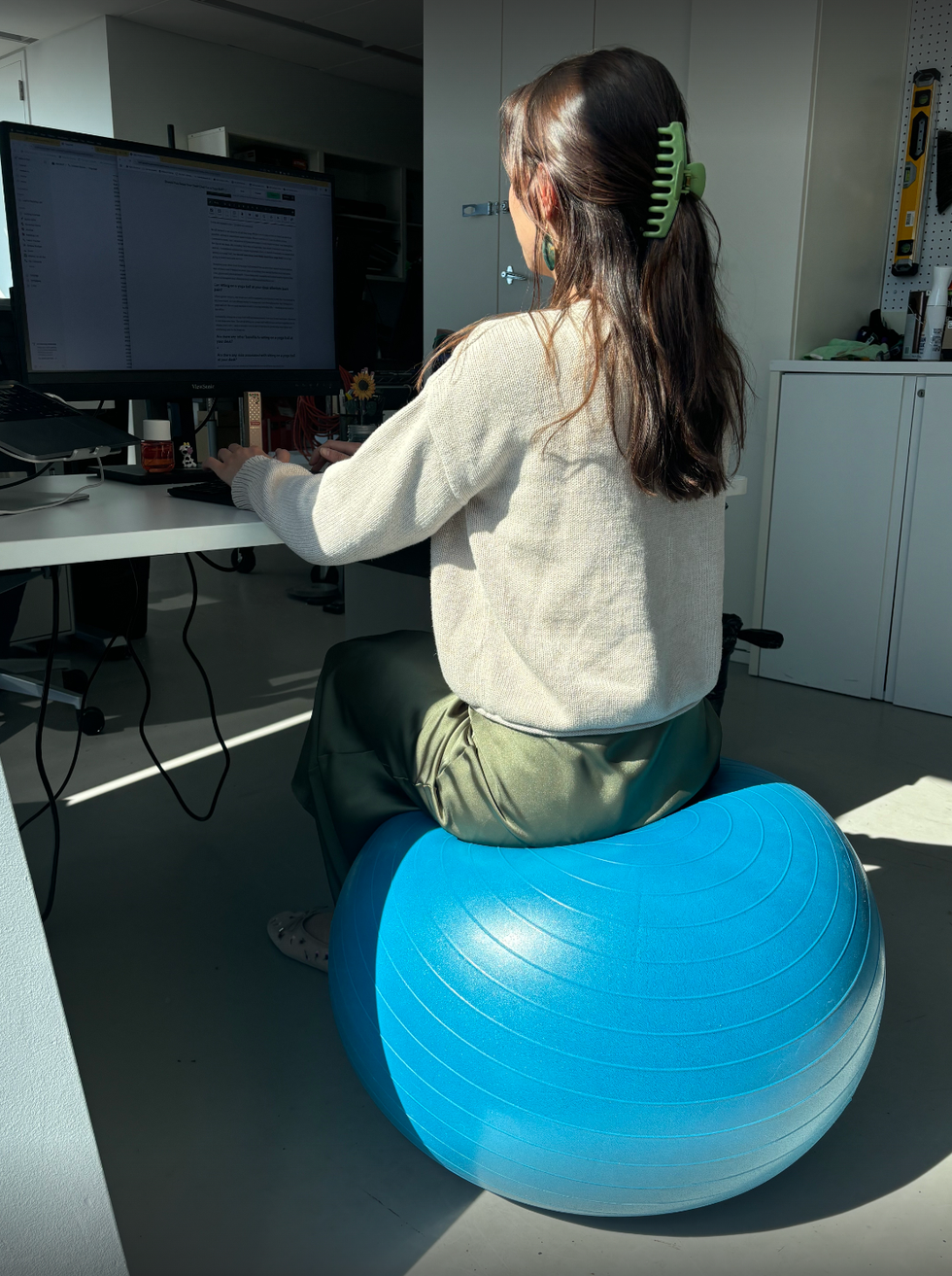 isabella cavallo working at her desk sitting on a yoga ball