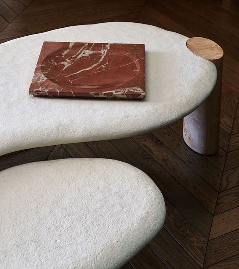 a white coffee table with a red marble tray