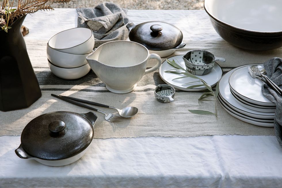 black and white ceramic dinnerware on linen tablecloth outside