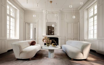 a white room with a white sofa and a chandelier