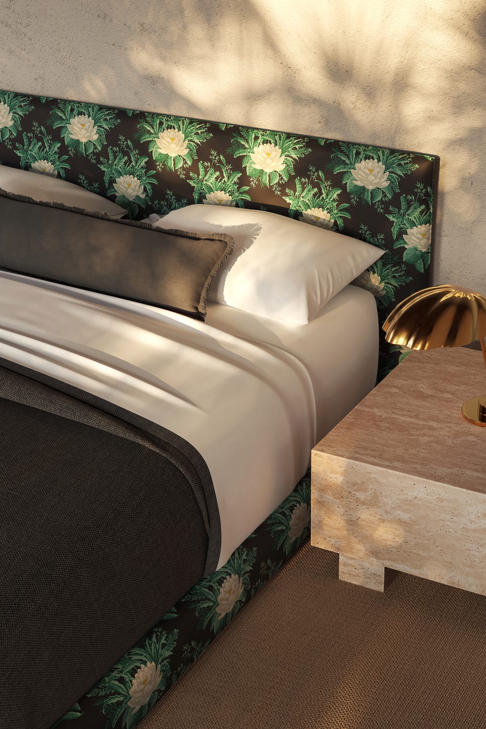 stylish bed setup with floral headboard and bedside lamp