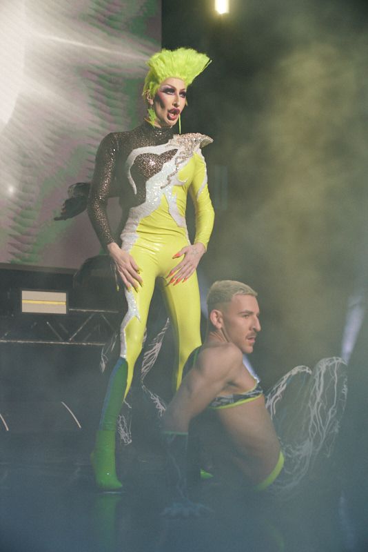 Yellow, Performance, Performance art, Fashion, Fictional character, Stage, Costume, Performing arts, Costume design, Latex clothing, 