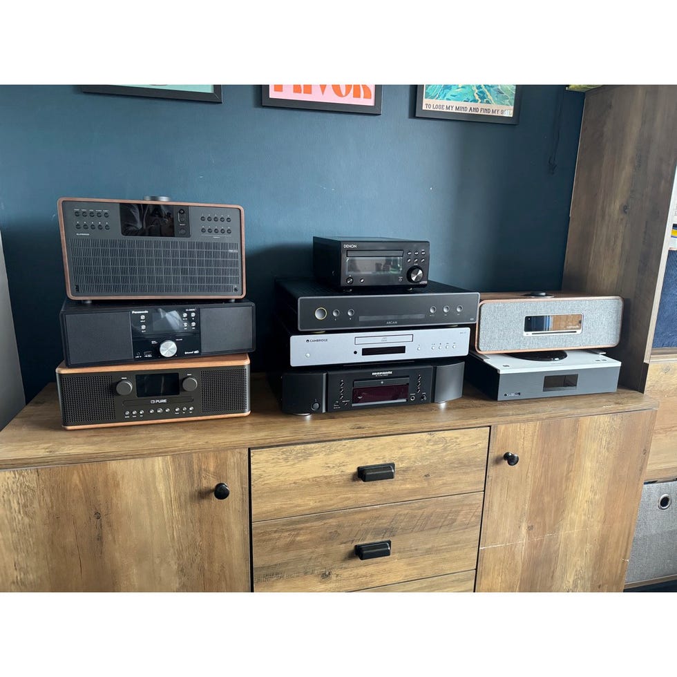 collection of cd players stacked on a wooden surface
