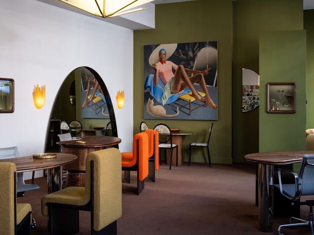 Artistic indoor space featuring unique furniture and a large mural.