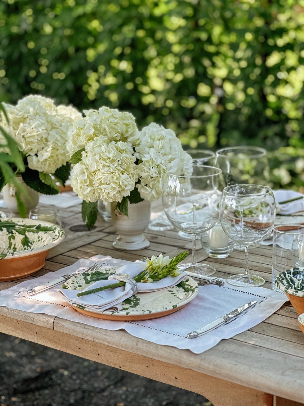 a table with glasses and plates of food on it