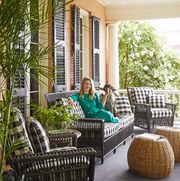 designer ceara donnelley sits on the porch of her charleston home wither her dog