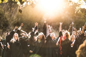 graduates throwing their caps in the air on graduation day