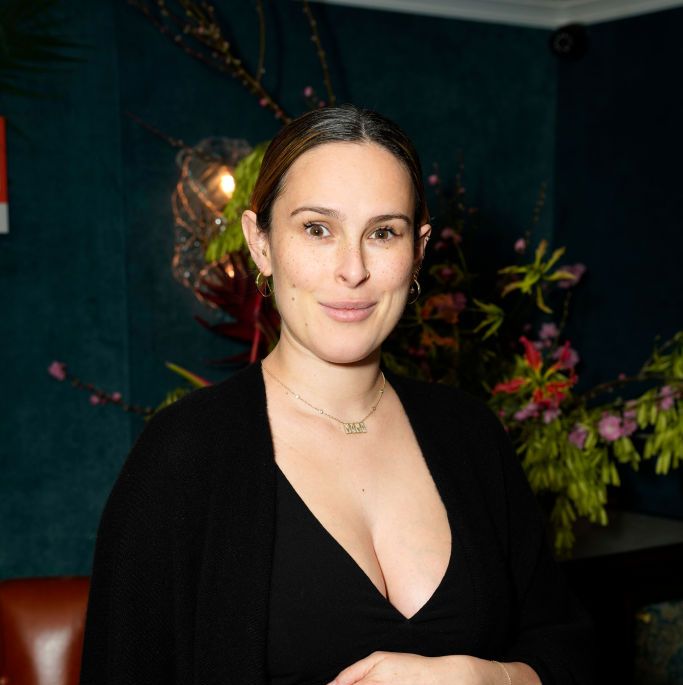 rumer willis poses while pregnant wearing black in a photo taken at an event