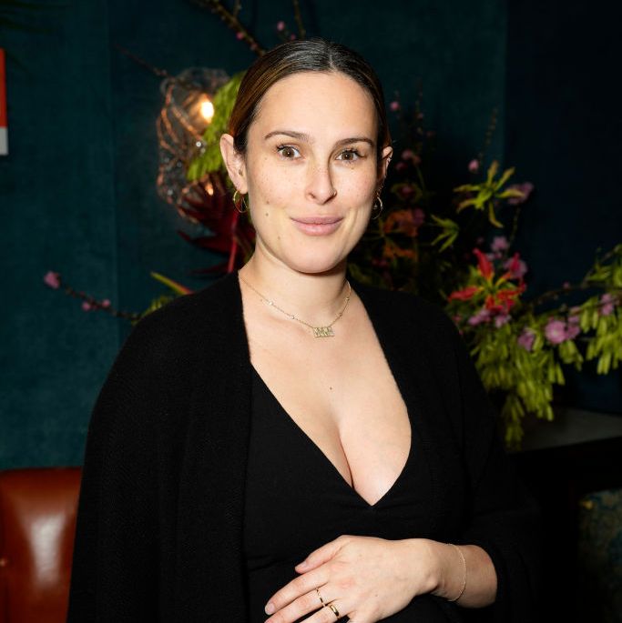 rumer willis poses while pregnant wearing black in a photo taken at an event