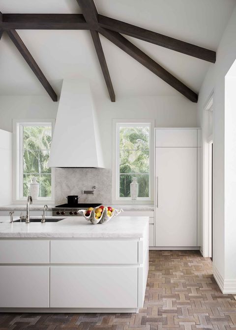 a crisp white kitchen with wood floors
