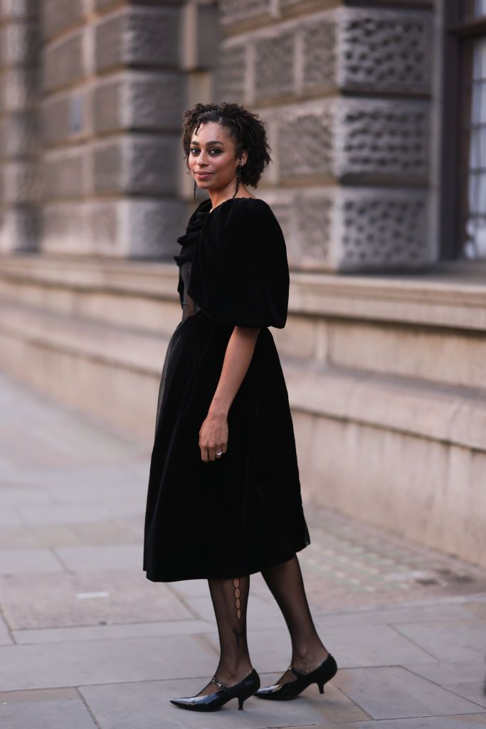 a woman at london fashion week wears a black dress and black tights to illustrate a guide of the best tights