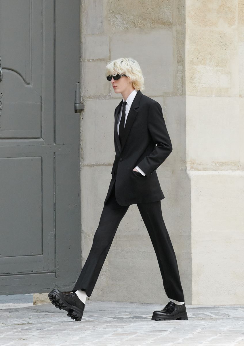 a person in a suit and sunglasses