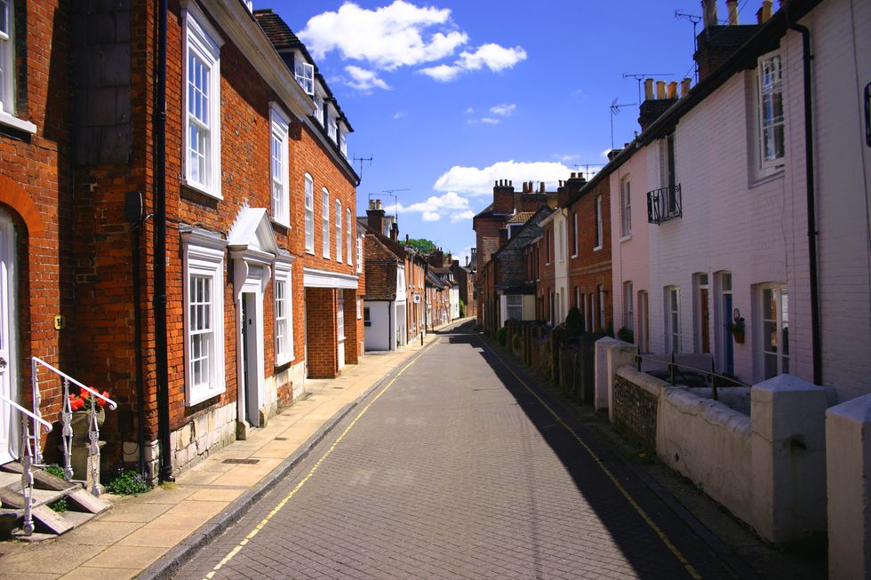Center view of an old English street on a partly cloudy day