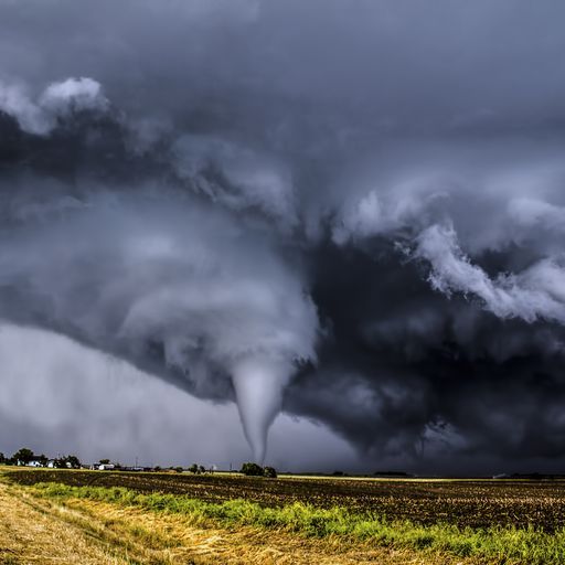 how tornadoes form, tornado seen in a field in the distance