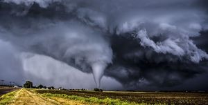 how tornadoes form, tornado seen in a field in the distance